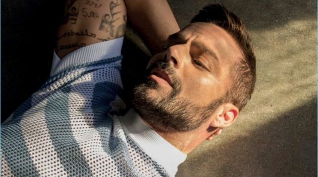 Starring in a photo shoot, Ricky Martin wears a striped mesh top by Prada.