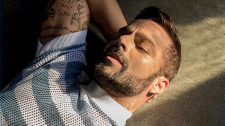 Starring in a photo shoot, Ricky Martin wears a striped mesh top by Prada.