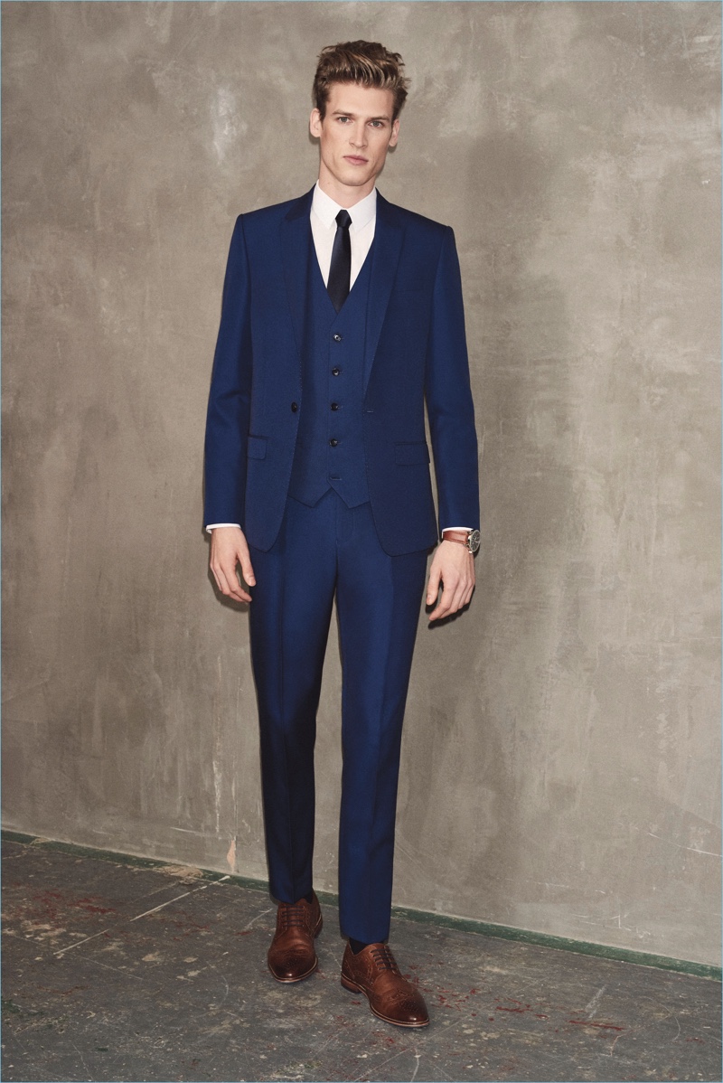 Embracing a traditional number, Joel Meacock wears a navy River Island suit.