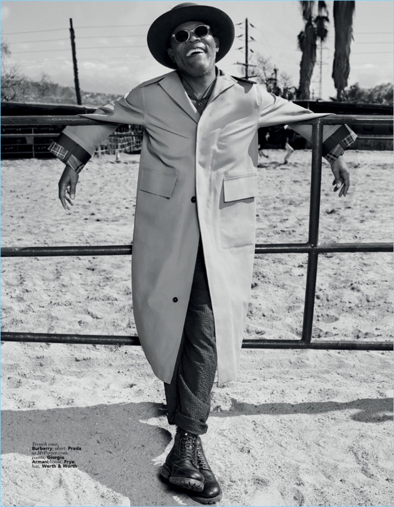 All smiles, Samuel L. Jackson dons a Burberry trench coat with a Prada shirt. Jackson also sports Giorgio Armani pants, Frye boots, and a hat by Worth & Worth.