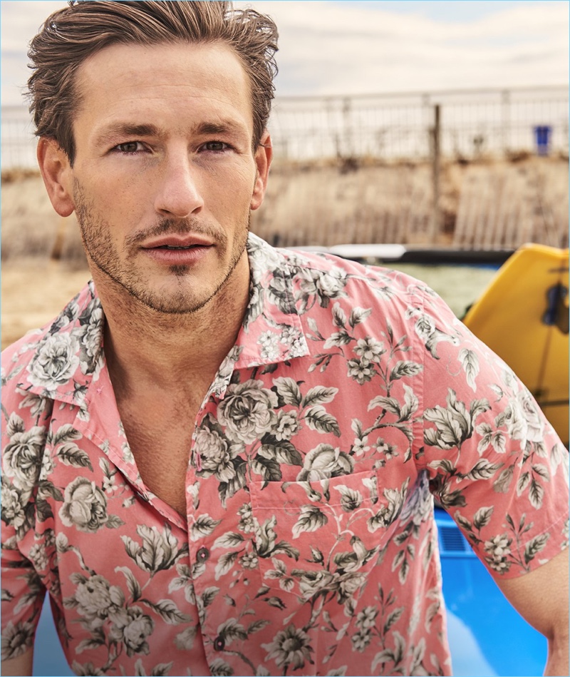 Model Parker Gregory sports a Todd Snyder short-sleeve Liberty print floral camp collar shirt.