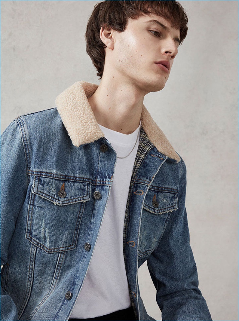 Ted Le Sueur wears a borg collar denim jacket by Topman.