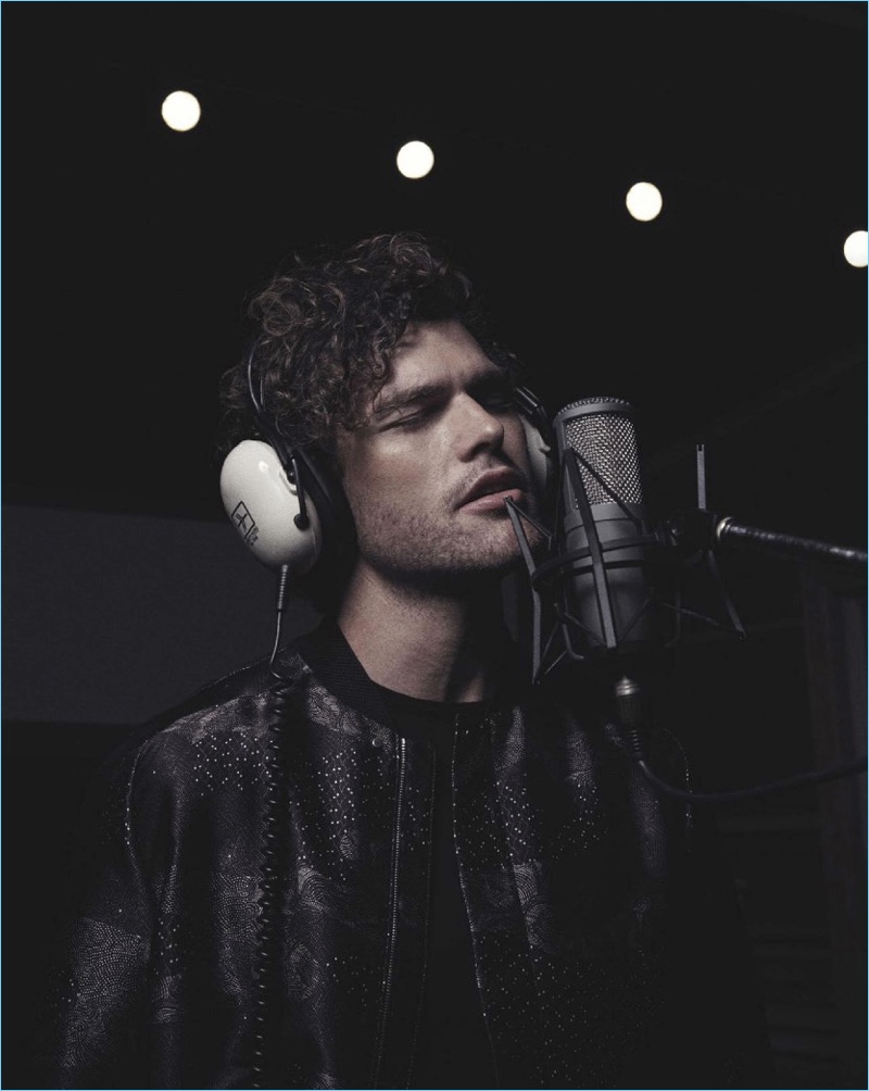 Taking to the studio, Vance Joy wears a bomber and tee by Emporio Armani.