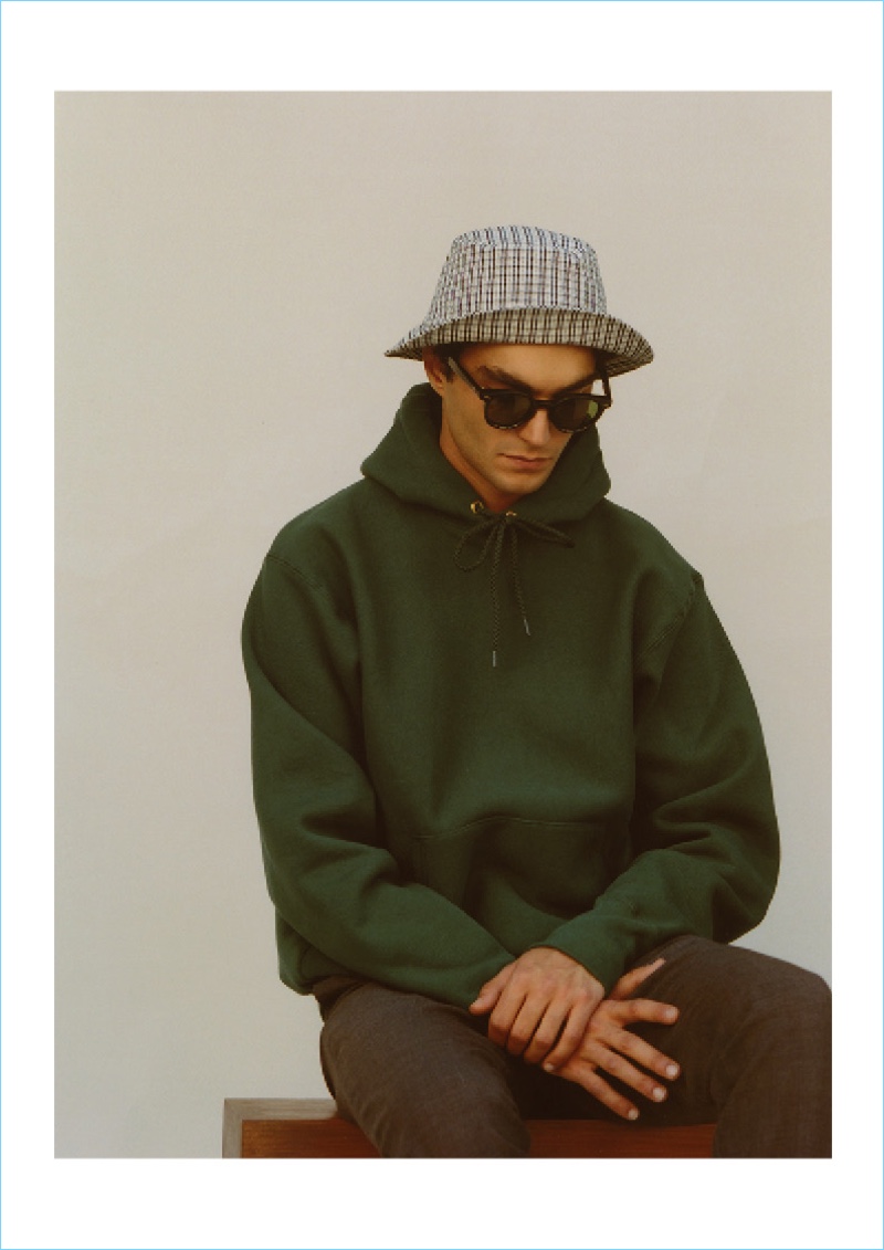 Going casual, Dylan Ézékiel Nelson rocks a Camber USA sweatshirt, Lock & Co. bucket hat, Husbands trousers, and Jacques Marie Mage sunglasses.