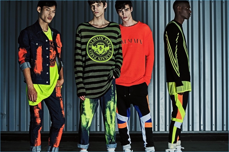 Models Chun Soot, Elias de Poot, Oussama Guessoum, and Rachide Embalo sport fluorescent colored outfits from Balmain's resort 2019 collection.