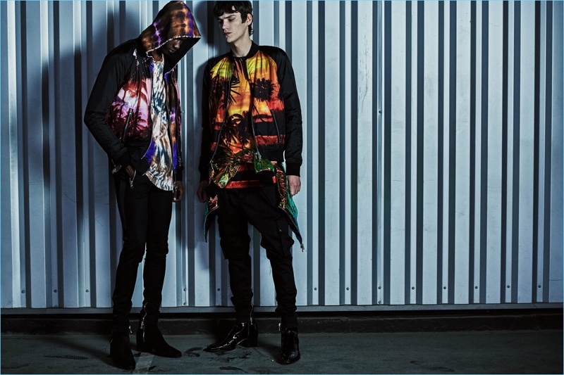 Rachide Embalo and Elias de Poot model Balmain bomber jackets with prints of a tropical sunset.