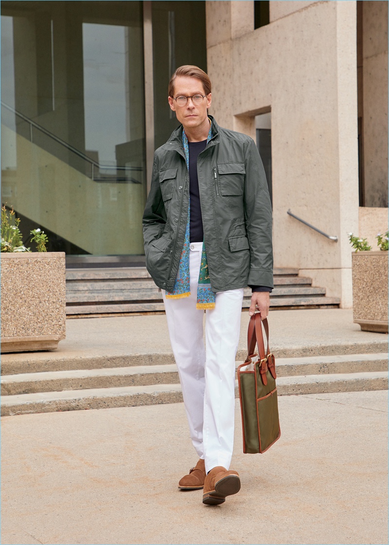 Ingo wears a Moorer field coat, PT05 jeans, and John Lobb shoes. He also sports Barton Perreira glasses and a Drake's scarf. 