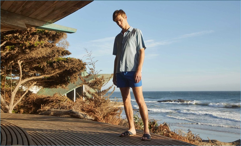 Sporting a shirt and swim shorts by Everest Isles, Ben Allen also wears Armando Cabral slide sandals. 