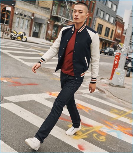 Satoshi Toda takes a stroll in a Coach 1941 varsity jacket.