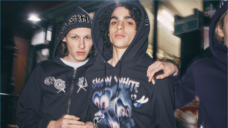 Models Samuel Wilken and Kobe Delgado wear sweatshirts from the Disney x Coach "A Dark Fairy Tale" collection.