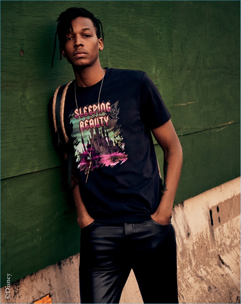 A casual vision, Matthew Davidson rocks a graphic tee from the Disney x Coach "A Dark Fairy Tale" collection.