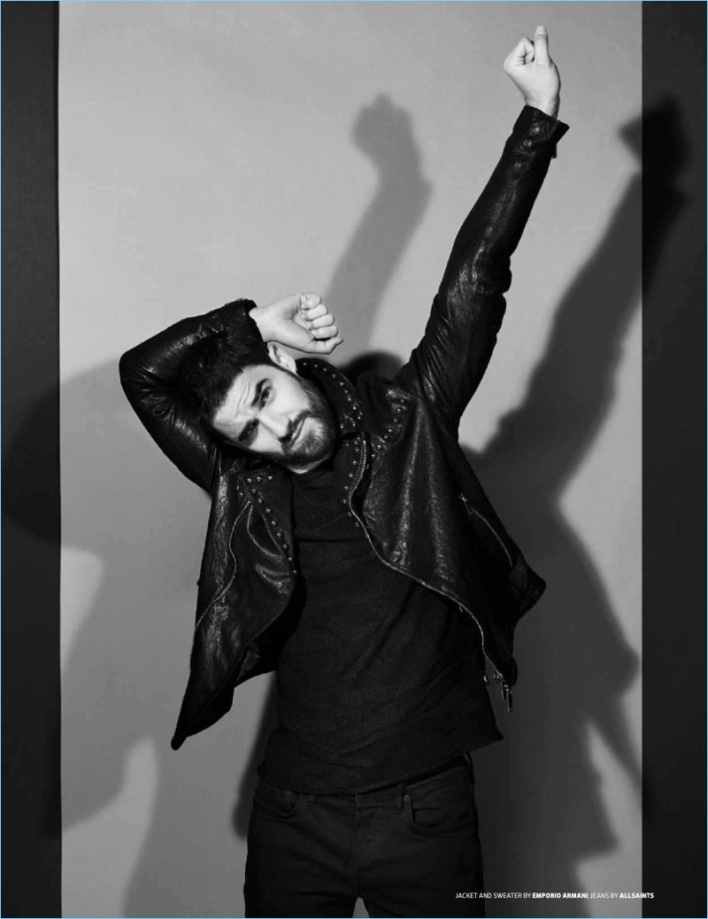 Darren Criss wears an Emporio Armani jacket and sweater with AllSaints jeans.