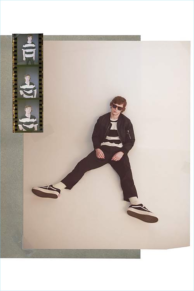 Starring in a photo shoot, Evan Peters wears a Rag & Bone bomber, Aloye + G.F.G.S. striped t-shirt, and Prada trousers. Vans sneakers and Gucci sunglasses complete Peters' look.