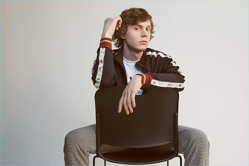 Evan Peters wears a Kapital track jacket with a Flagstuff t-shirt and Wacko Maria trousers.