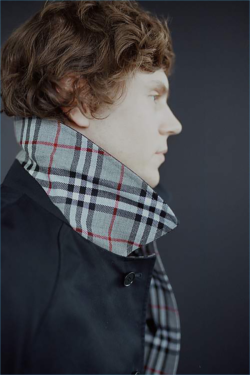Offering up a side profile, Evan Peters wears a Burberry coat.