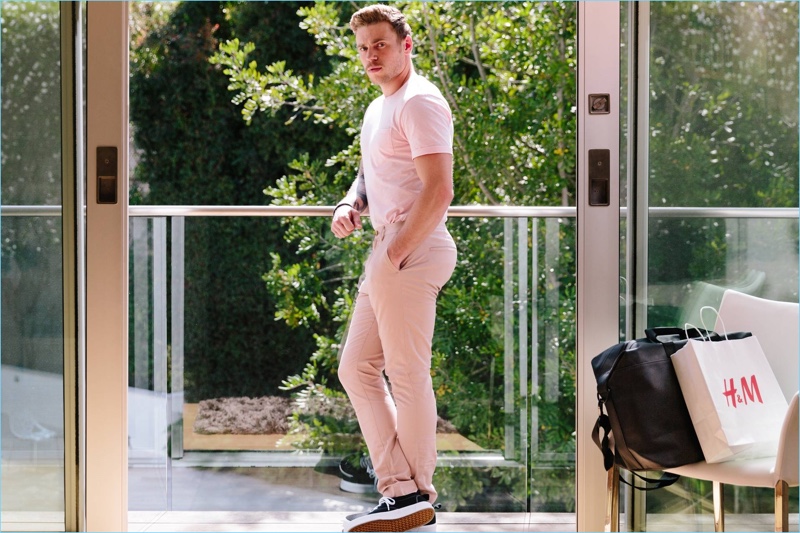 Gus Kenworthy makes a statement in pink. He wears a H&M round-necked t-shirt and chinos.