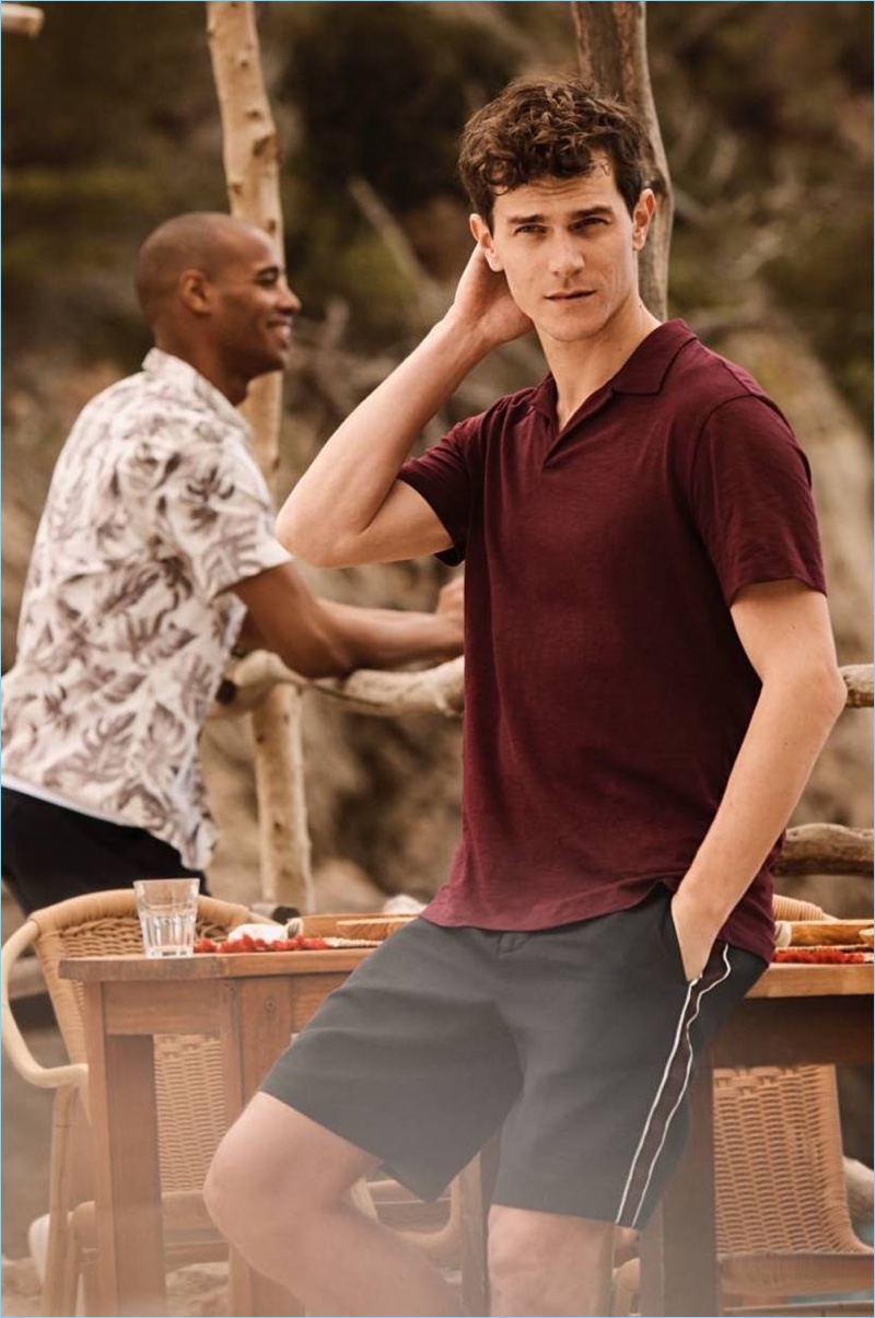 Vincent LaCrocq models a H&M polo shirt in burgundy with slim-fit city shorts.