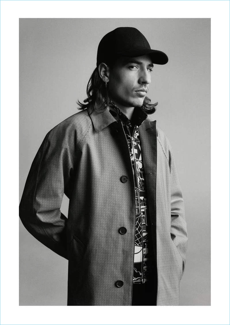 Connecting with Mr Porter, Héctor Bellerín wears Berluti jeans with a Prada coat, printed jacket, and t-shirt.