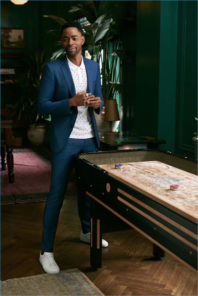 Remixing the suit, Jay Ellis dons a BOSS number with a polo shirt.