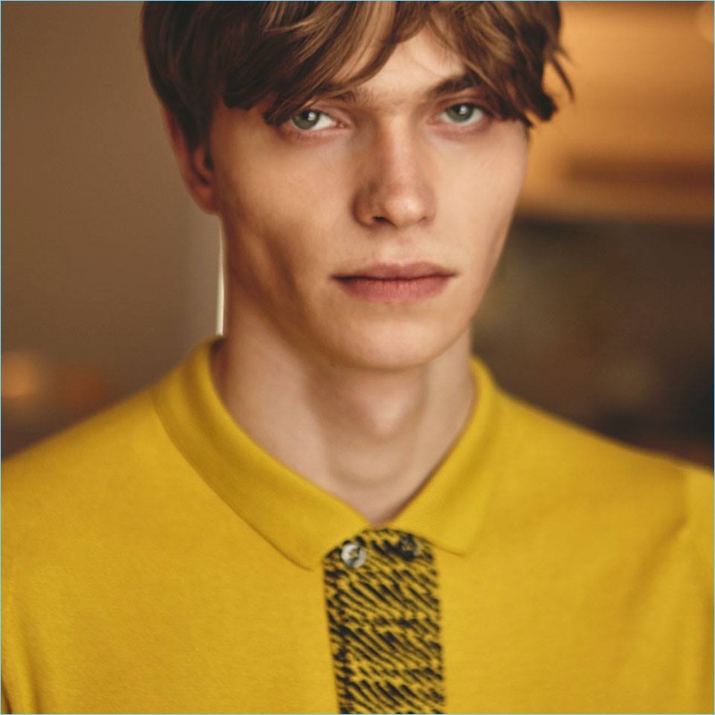 Embracing a pop of color, Jake Love wears a yellow polo from John Smedley.