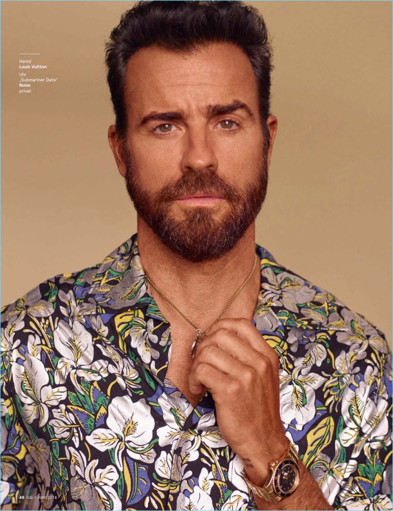 Front and center, Justin Theroux wears a Louis Vuitton shirt and Rolex watch.