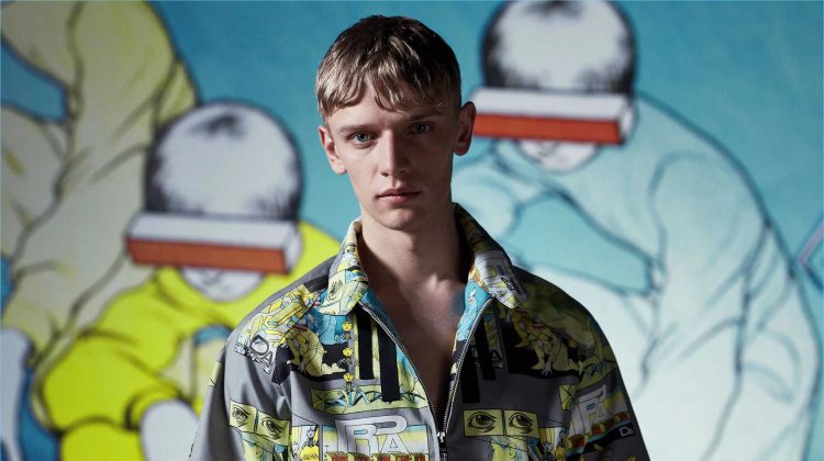 Front and center, Peter Dupont wears a Prada comic-print short-sleeved jacket.