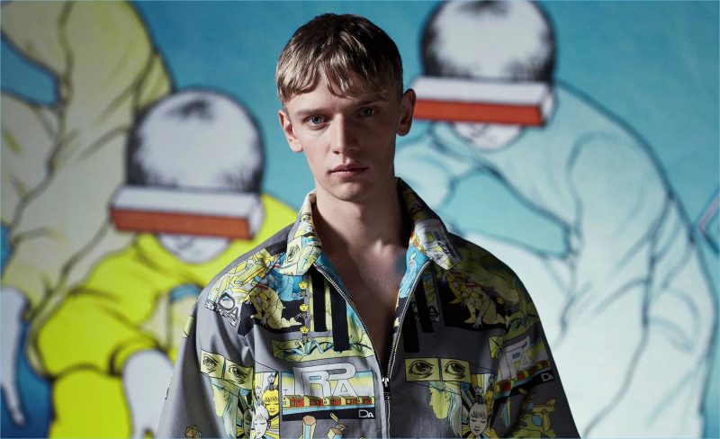 Front and center, Peter Dupont wears a Prada comic-print short-sleeved jacket.