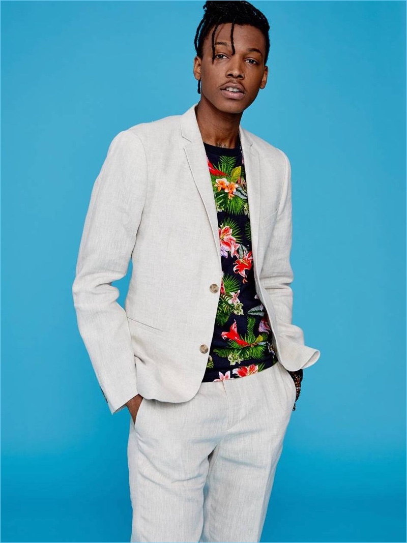 Sporting a chic number, Matthew Davidson dons a H&M slim-fit linen blazer and suit pants.  He also wears a tropical print t-shirt.