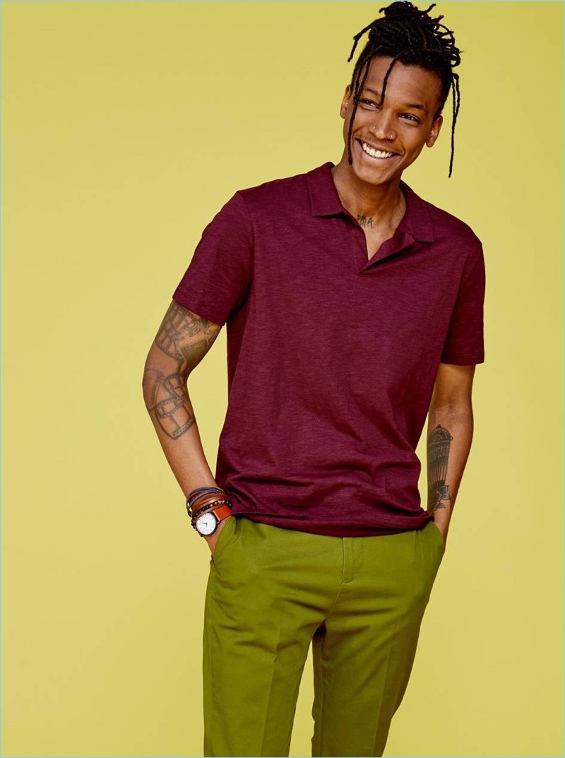 All smiles, Matthew Davidson dons a polo shirt and chinos from H&M.