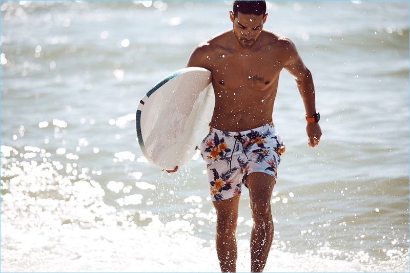 Daniel Pimentel takes to the beach in floral print swim shorts from Nautica.