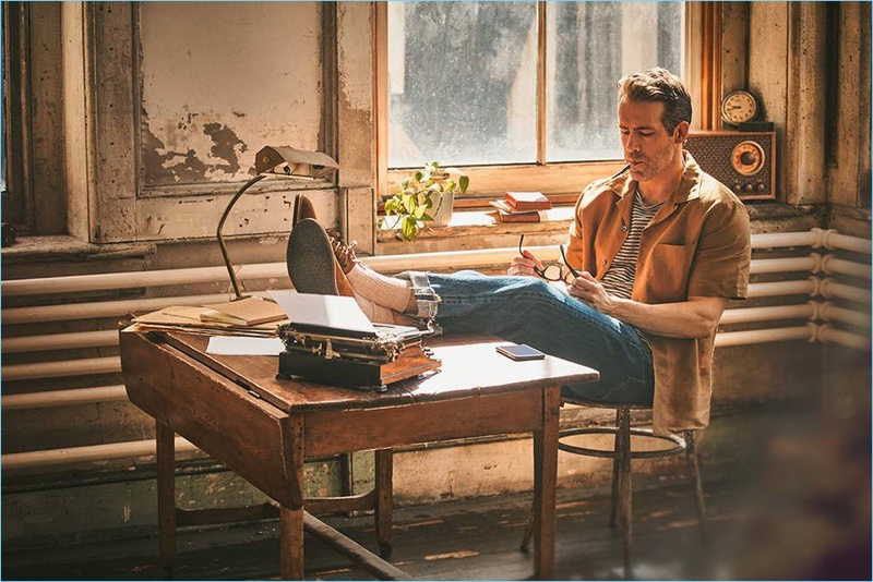Starring in a Mr Porter photo shoot, Ryan Reynolds dons a Margaret Howell linen shirt, Schiesser striped t-shirt, and Chimala selvedge denim jeans. The Canadian actor also wears Anonymous Ism knitted socks, and Lanvin suede derby shoes.