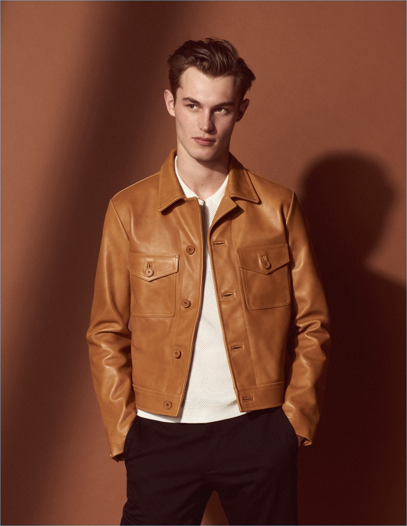 Kit Butler dons a brown leather jacket from Sandro's Mr Porter summer capsule collection.