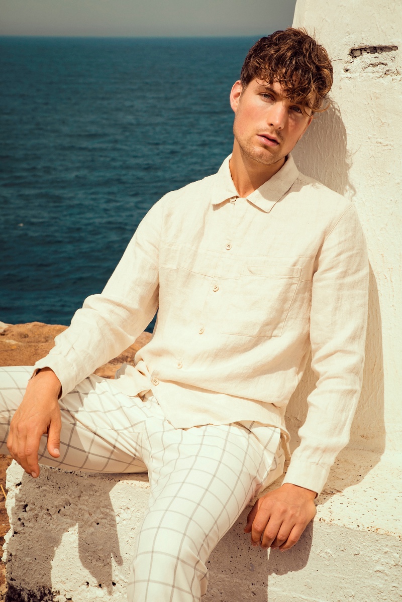 Donning summer neutrals, Saxon wears a linen shirt and windowpane print pants from Zara.