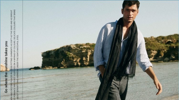 Connecting with Massimo Dutti, Sean O'Pry wears a linen band collar shirt. He also dons a linen scarf and chinos.
