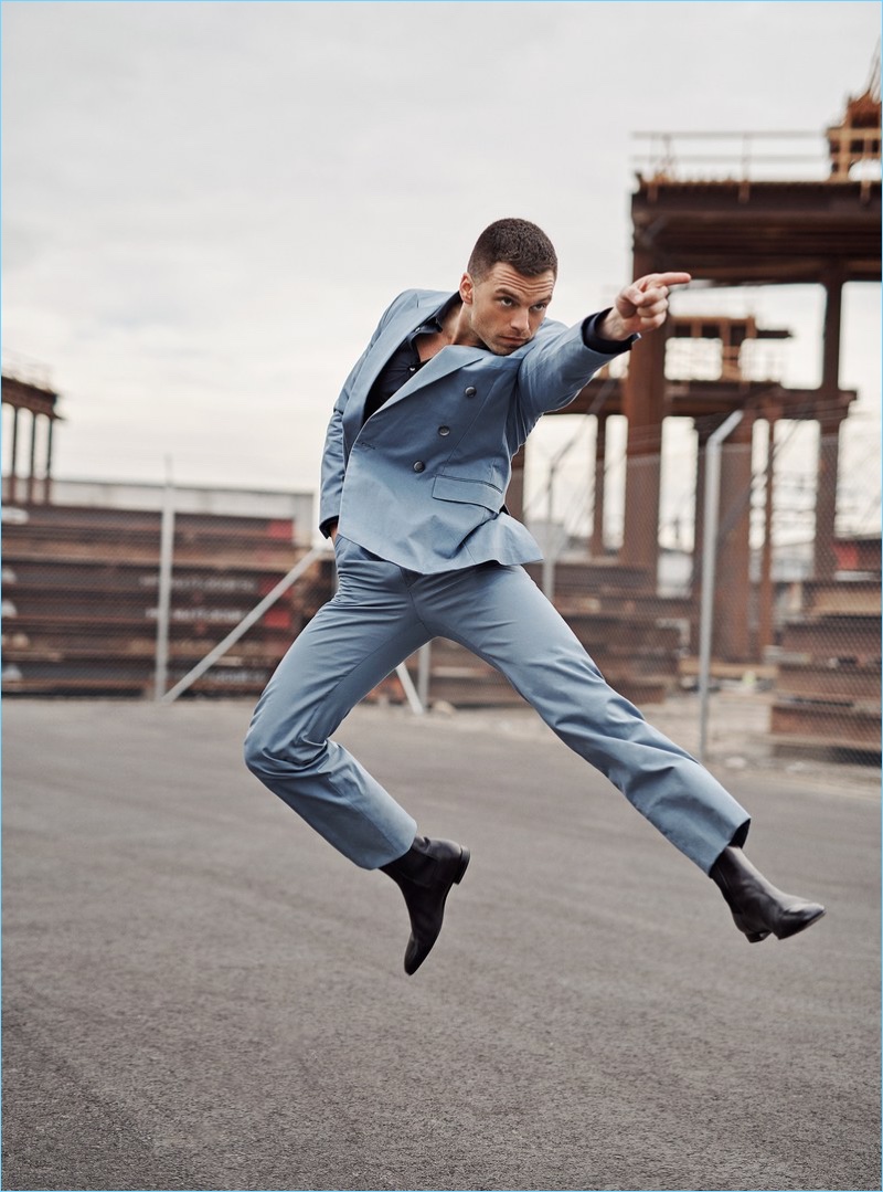 Striking a pose, Sebastian Stan wears a BOSS suit with a Stella McCartney shirt and Christian Louboutin boots.