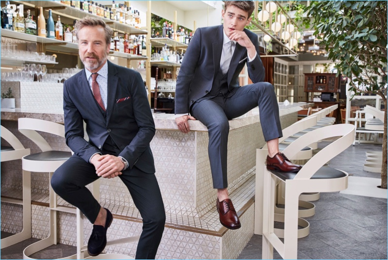 Rainer Andreesen wears a Gianni Lupo striped suit in navy. Meanwhile, Bo Develius dons a LE 31, shirt, suit, and tie with Steve Madden derby shoes.