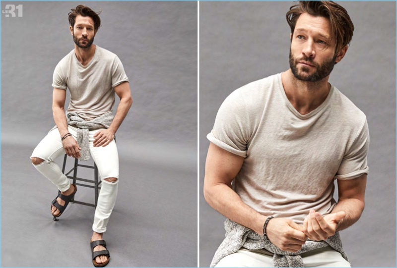 Playing it casual, John Halls sports a LE 31 stretch linen t-shirt and ripped white jeans. Tying a heather sweater around his waist, he also wears Birkenstock sandals.