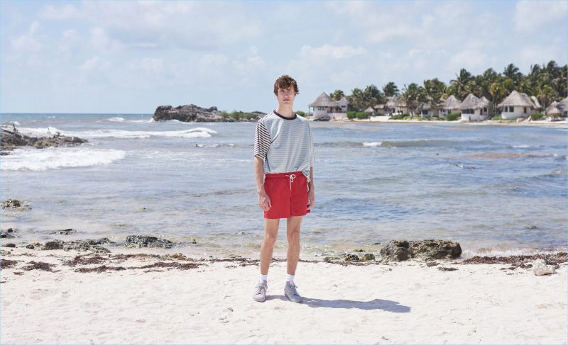 Tim Dibble wears a striped t-shirt by Marni with Solid & Striped swim shorts. He also sports Eytys sneakers and Balenciaga logo socks.