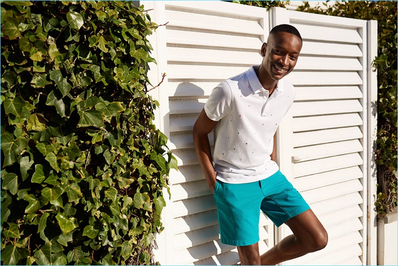 A smart summer vision, Oliver Kumbi wears a Tommy Hilfiger polo shirt and shorts.