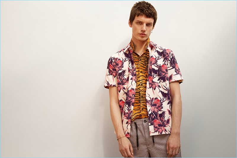 Layering for a bold effect, Theo Neilson wears a floral printed short-sleeve shirt with a tiger print shirt from Topman.