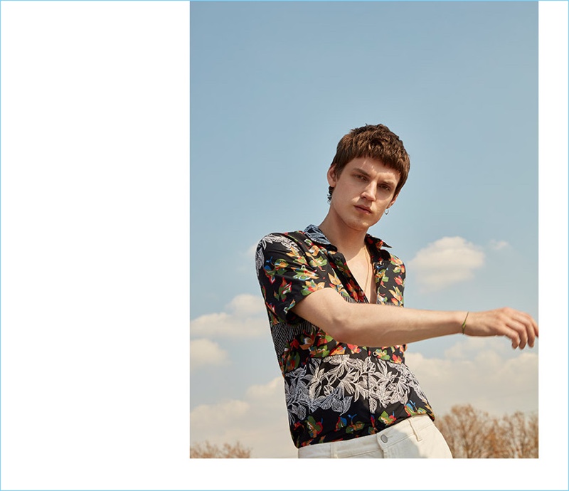 Connecting with Topman, Theo Neilson wears a multi leaf printed short-sleeve shirt.