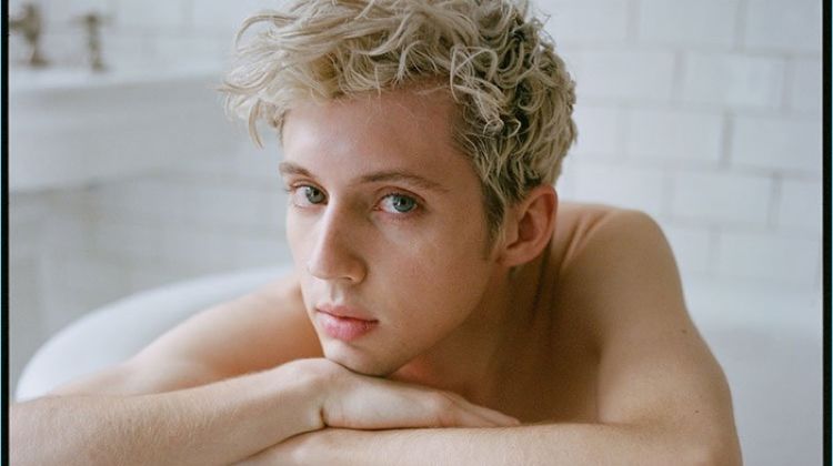 Posing in a bathtub, Troye Sivan rests on a Stella McCartney sweater.