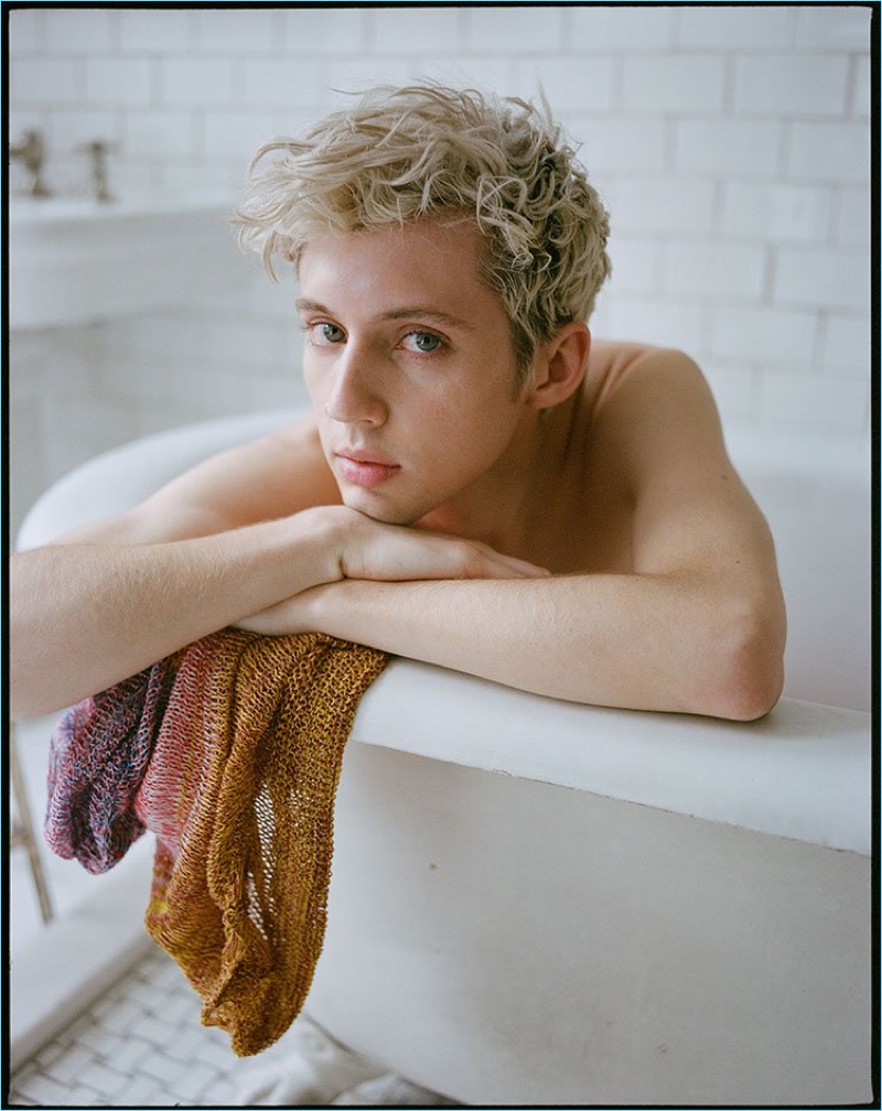 Posing in a bathtub, Troye Sivan rests on a Stella McCartney sweater.