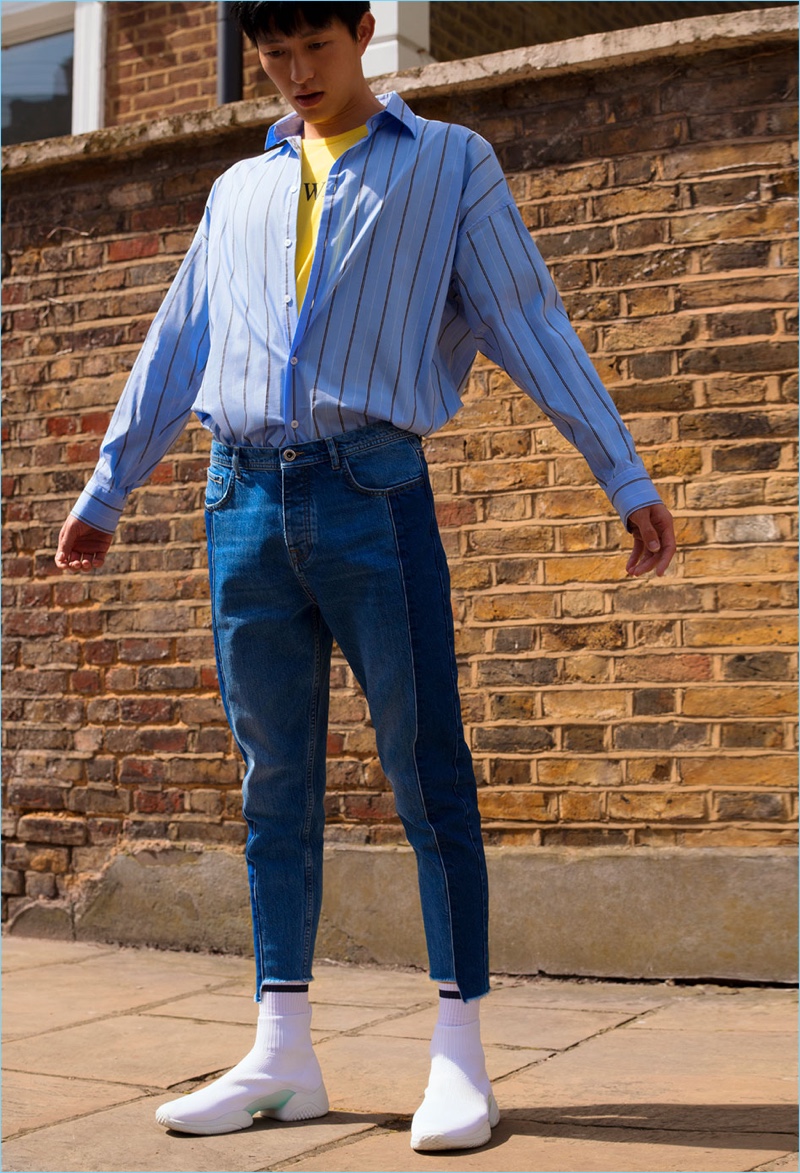 Jin Dachuan rocks denim jeans with sock sneakers, a shirt, and graphic tee from Zara Man.