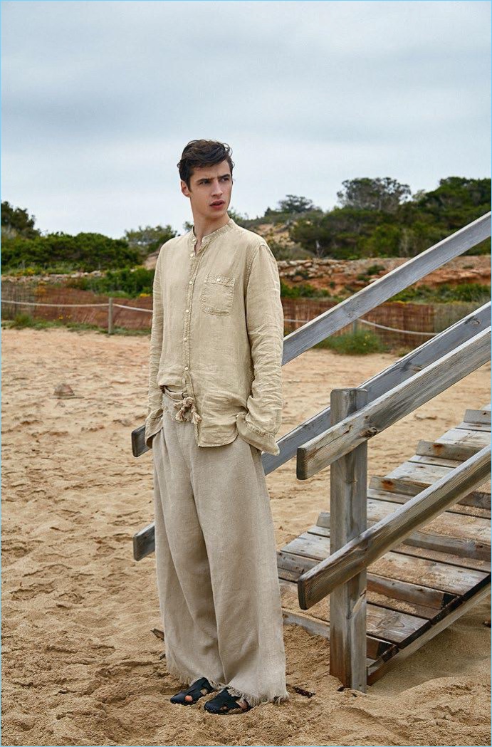 Donning neutrals, Adrien Sahores wears a Woolrich shirt, Homme Plissé Issey Miyake pants, and Hermès sandals. 