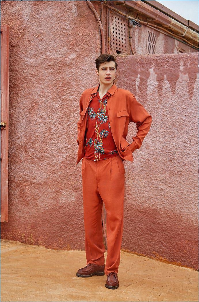 Adrien Sahores wears a shirt and pants by Lemaire. The French model also sports a tropical print shirt from The Kooples with Paraboot shoes.