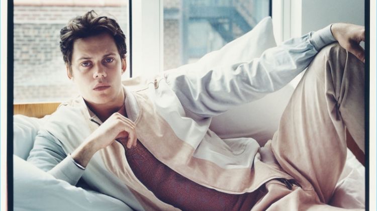 Relaxing in bed, Bill Skarsgård wears Ermenegildo Zegna Couture.