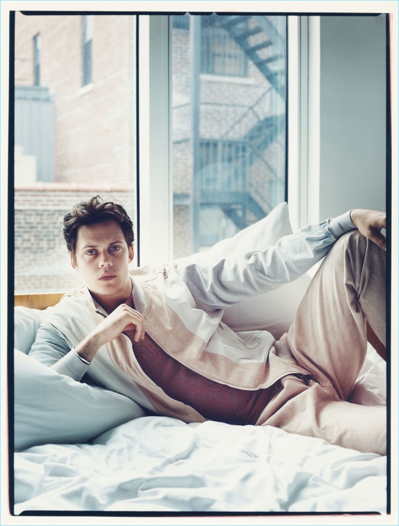 Relaxing in bed, Bill Skarsgård wears Ermenegildo Zegna Couture.