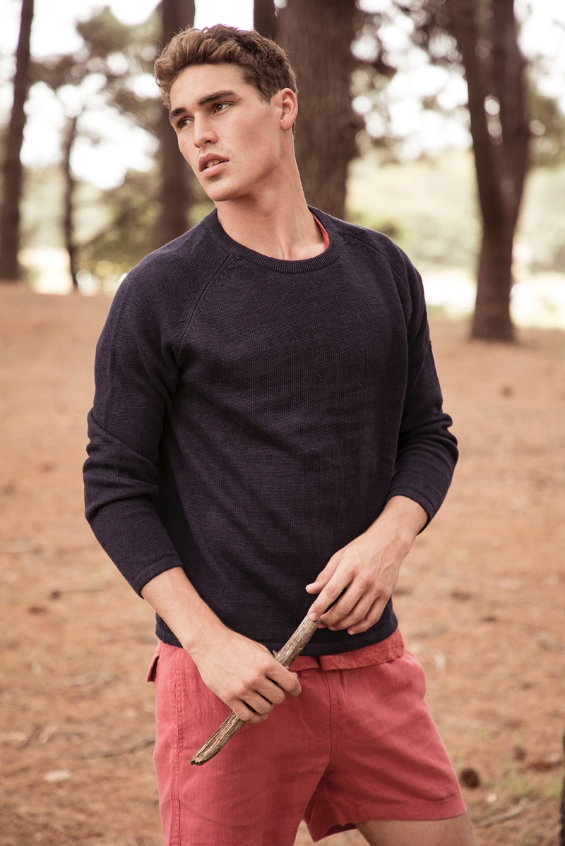 Pat Supsiri photographs Brayden in a navy sweater and red shorts by Venroy.