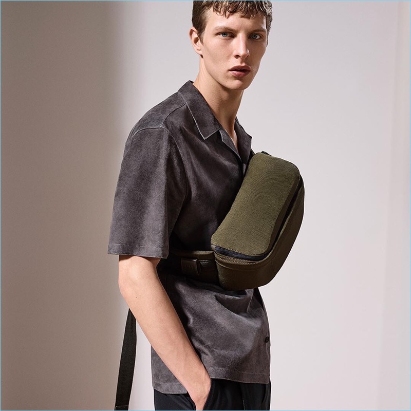 Model Tim Schuhmacher sports Dunhill's trendy belt bag with a suede shirt.